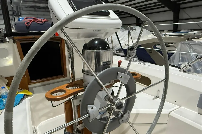 Slide: The Image of Steering wheel of a 1986 Sabre 34 MK II sailboat in a marina setting. - 6