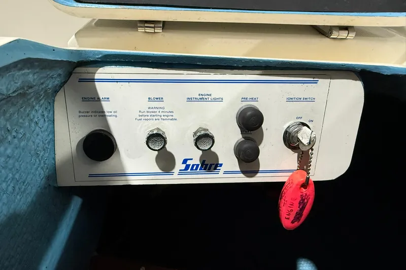 Slide: The Image of Control panel of a 1986 Sabre 34 MK II boat with ignition switch and engine controls. - 8