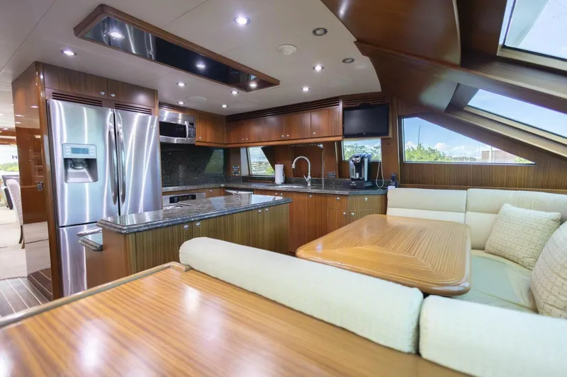 Slide: The Image of Luxurious dining area on 2009 Hargrave Enclosed Bridge yacht with elegant wood finishes. - 17