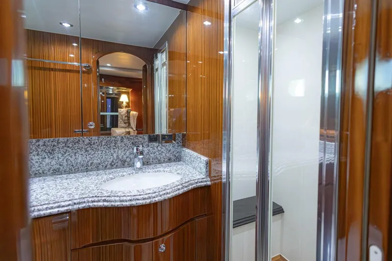 Slide: The Image of Luxurious bathroom in 2009 Hargrave Enclosed Bridge yacht with wood paneling and granite countertop. - 43