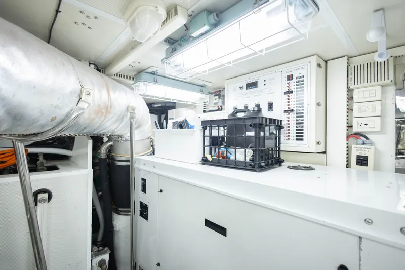 Slide: The Image of Engine room of 2009 Hargrave Enclosed Bridge yacht, featuring control panels and machinery. - 85