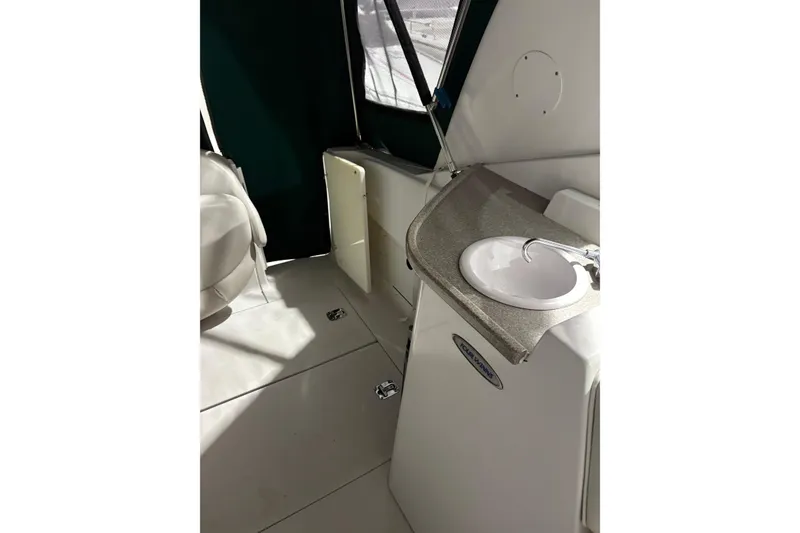 Slide: The Image of 2003 Four Winns 328 Vista boat interior with sink and seating area. - 12