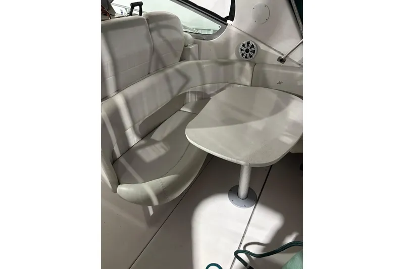 Slide: The Image of 2003 Four Winns 328 Vista boat interior with seating and table. - 13