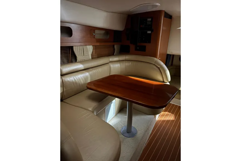 Slide: The Image of Interior of 2003 Four Winns 328 Vista boat with leather seating and wooden table. - 15