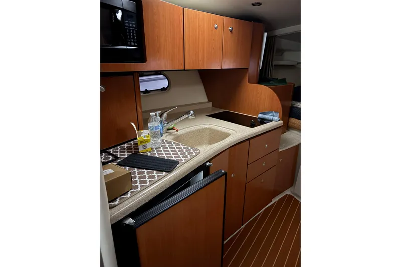Slide: The Image of 2003 Four Winns 328 Vista boat kitchen with wood cabinets and modern appliances. - 17