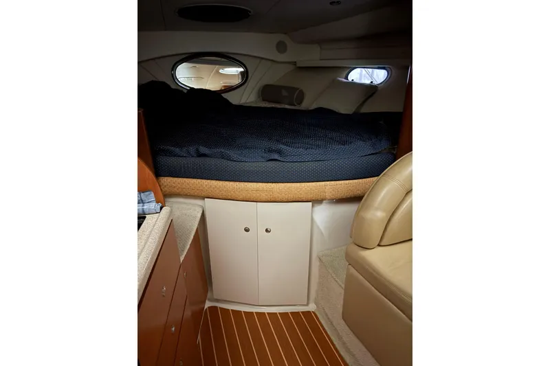 Slide: The Image of 2003 Four Winns 328 Vista cabin interior with bed, storage, and seating. - 18
