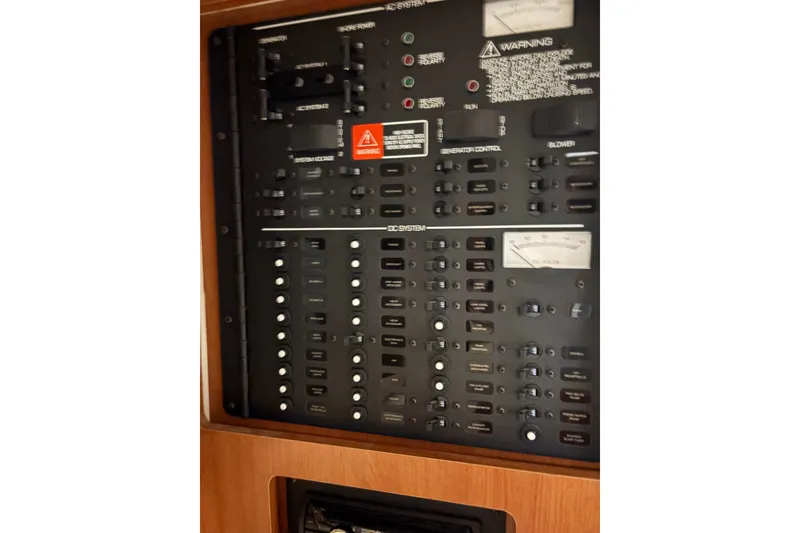 Slide: The Image of Electrical control panel of 2003 Four Winns 328 Vista boat, featuring various switches and gauges. - 20