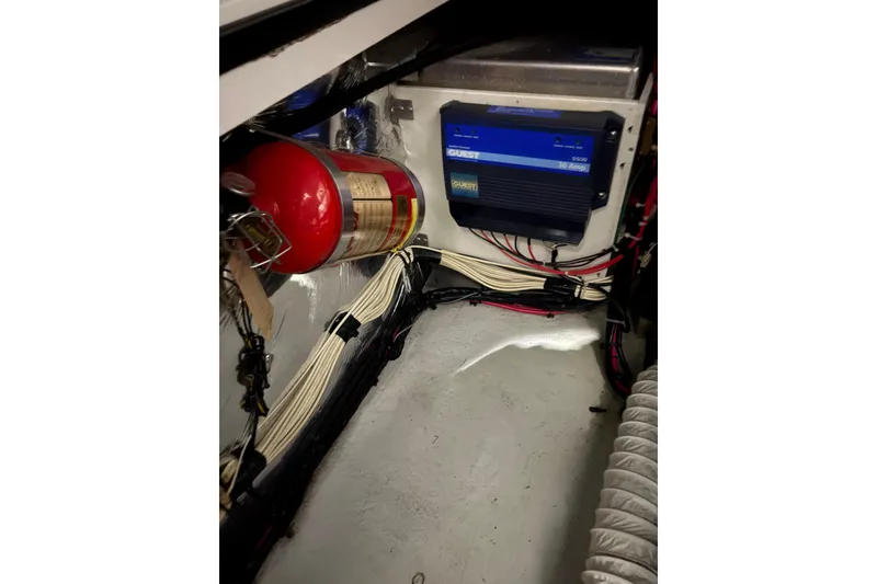 Slide: The Image of 2003 Four Winns 328 Vista engine compartment with fire extinguisher and electrical components. - 22