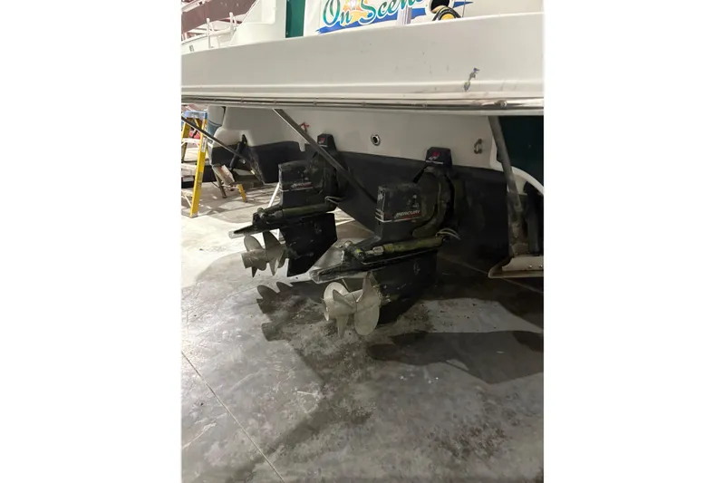 Slide: The Image of 2003 Four Winns 328 Vista boat with dual propellers in a garage setting. - 4