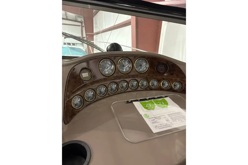 Slide: The Image of Dashboard of a 2003 Four Winns 328 Vista boat with multiple gauges and controls. - 6