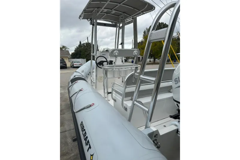 Slide: The Image of 2023 Ribcraft 5.85 boat with sleek design and sturdy construction, docked outdoors. - 1