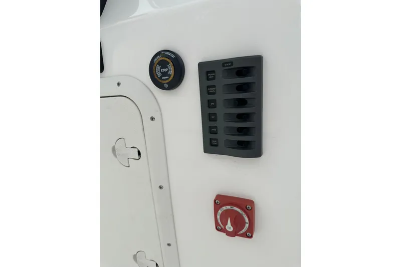 Slide: The Image of Control panel on 2023 Ribcraft 5.85 boat with switches and gauges. - 13