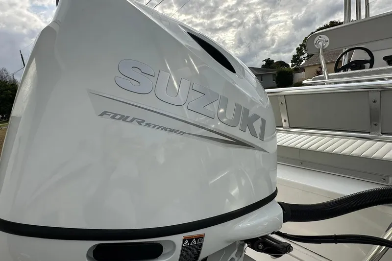 Slide: The Image of Suzuki four-stroke engine on 2023 Ribcraft 5.85 boat, showcasing sleek design and power. - 15