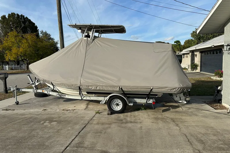 Slide: The Image of Covered 2023 Ribcraft 5.85 boat on trailer in residential driveway. - 18