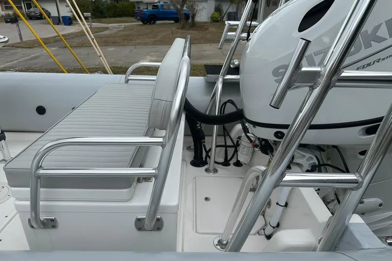 Slide: The Image of 2023 Ribcraft 5.85 boat interior with Suzuki engine and seating area. - 2