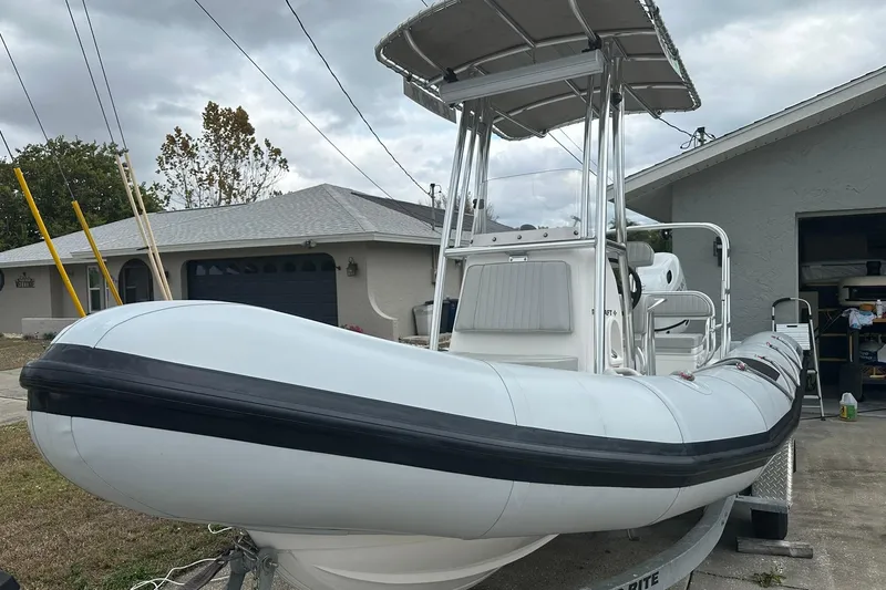 Slide: The Image of 2023 Ribcraft 5.85 inflatable boat on trailer, parked in residential driveway. - 4