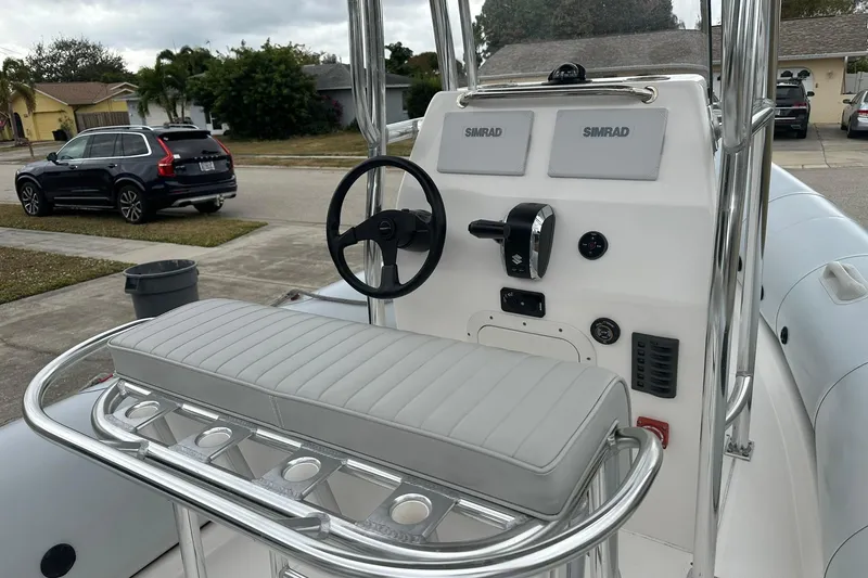 Slide: The Image of 2023 Ribcraft 5.85 boat console with steering wheel and Simrad electronics. - 9