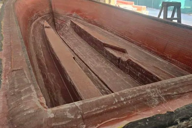 Slide: The Image of 2026 Albury Brothers 23 boat hull in a workshop, suspended above a mold. - 2