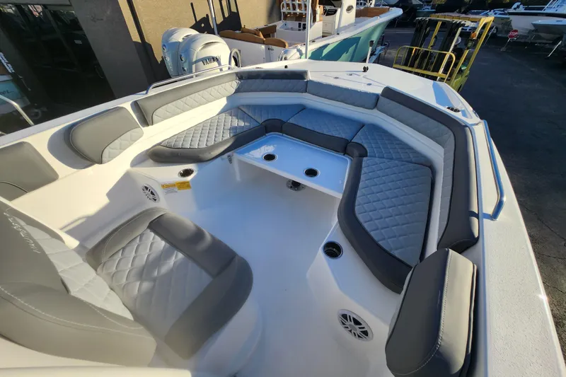 Slide: The Image of 2026 NauticStar 231 Hybrid boat interior with gray cushioned seating and modern design. - 10