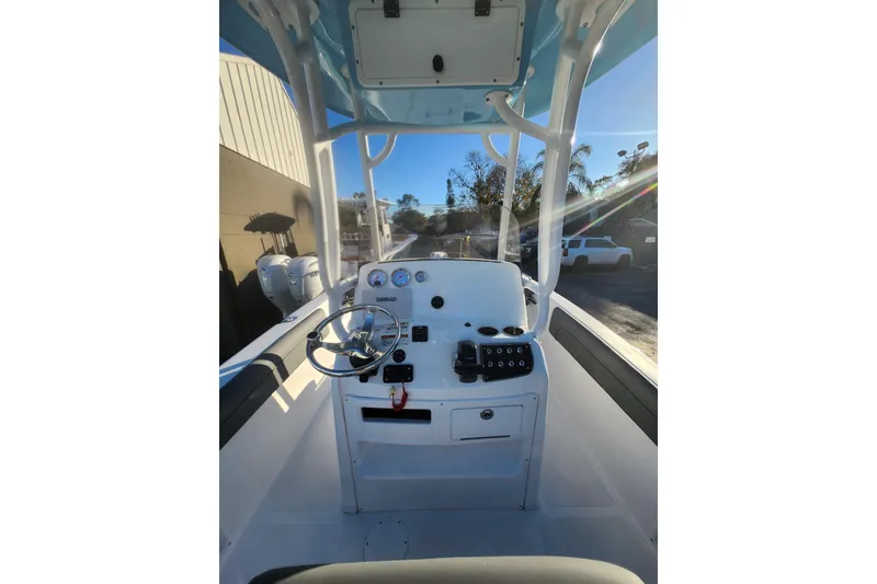 Slide: The Image of 2026 NauticStar 231 Hybrid boat console with steering wheel and controls. - 5