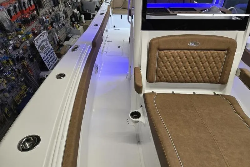 Slide: The Image of 2026 Sea Hunt Ultra 275 Coffin Box interior with tan seating and modern design. - 10