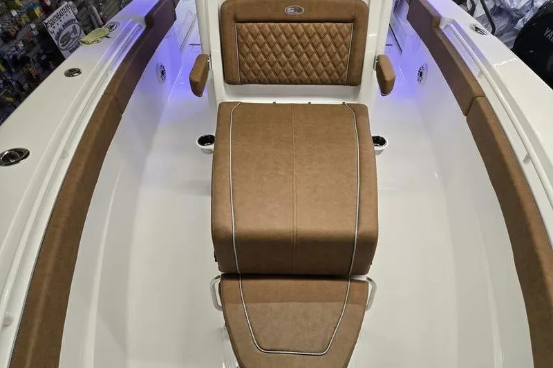 Slide: The Image of 2026 Sea Hunt Ultra 275 Coffin Box interior with brown cushioned seating. - 13