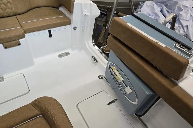 Slide: The Image of 2026 Sea Hunt Ultra 275 Coffin Box interior with brown seating and storage compartments. - 15