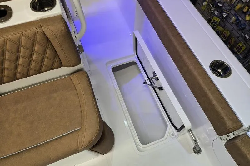 Slide: The Image of 2026 Sea Hunt Ultra 275 Coffin Box interior with brown seating and storage compartment. - 20