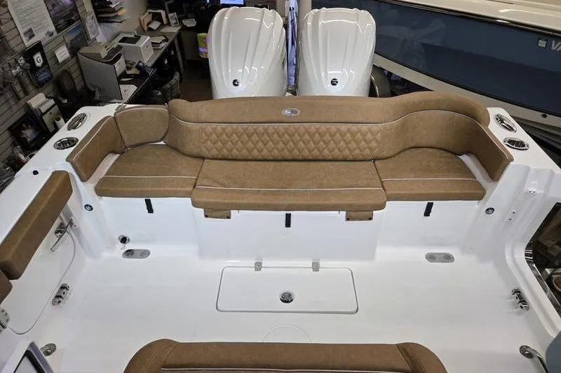 Slide: The Image of 2026 Sea Hunt Ultra 275 Coffin Box boat interior with tan seating and dual engines. - 22
