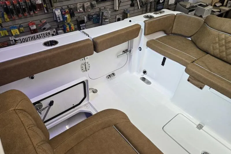 Slide: The Image of Interior of 2026 Sea Hunt Ultra 275 Coffin Box boat with tan seating and storage. - 23