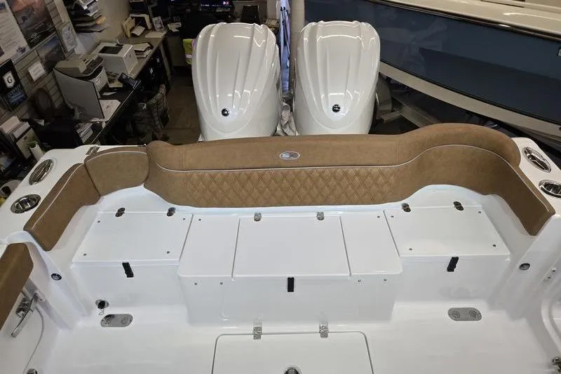 Slide: The Image of 2026 Sea Hunt Ultra 275 Coffin Box boat interior with cushioned seating and storage compartments. - 24