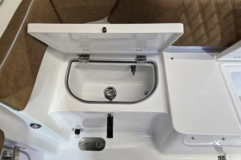 Slide: The Image of 2026 Sea Hunt Ultra 275 Coffin Box interior with open storage compartment. - 26