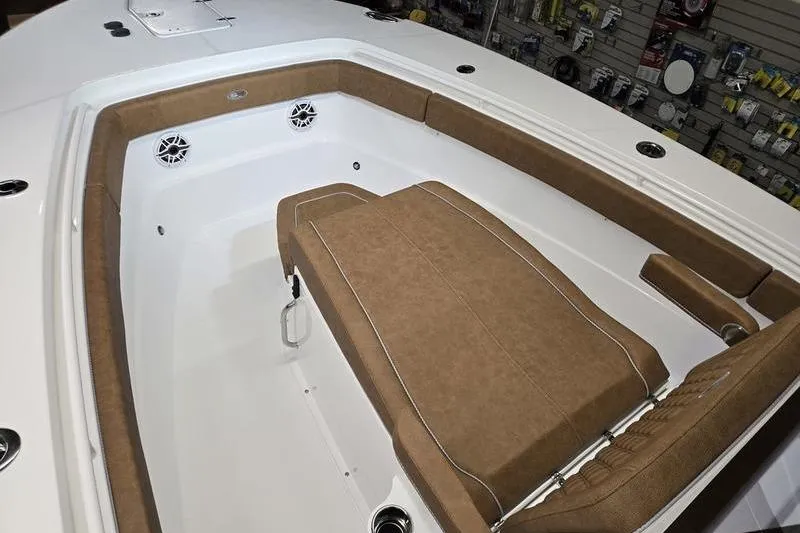 Slide: The Image of 2026 Sea Hunt Ultra 275 Coffin Box boat interior with brown cushioned seating. - 3