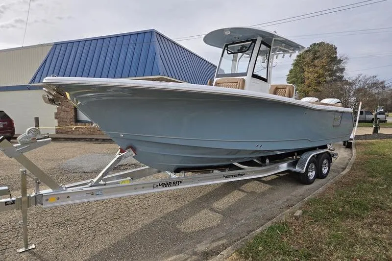Slide: The Image of 2026 Sea Hunt Ultra 275 Coffin Box boat on trailer, parked outdoors. - 4