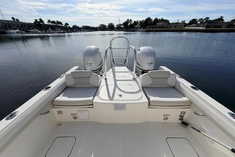 Slide: The Image of 2026 World Cat 230 DC boat with dual engines on a calm lake. - 10