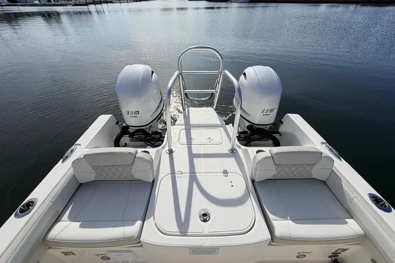 Slide: The Image of 2026 World Cat 230 DC boat with twin Yamaha 115 engines on calm water. - 11