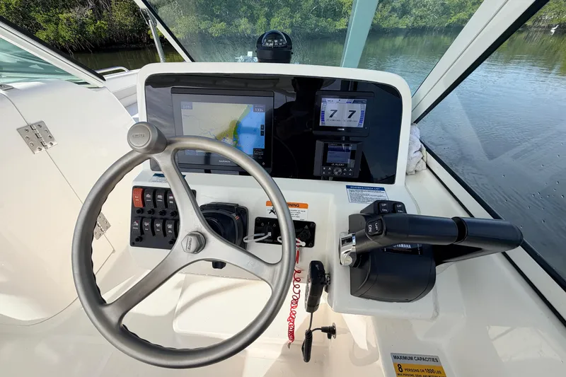 Slide: The Image of Helm of 2026 World Cat 230 DC boat with navigation display and controls. - 16