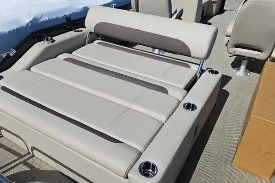 Slide: The Image of 2025 Bentley Pontoons Legacy 243 Swingback seating area with cup holders and beige upholstery. - 3