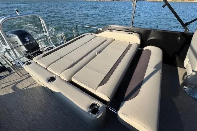 Slide: The Image of 2025 Bentley Pontoons Legacy 243 Swingback with luxurious seating on a serene lake. - 4