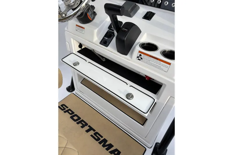 Slide: The Image of 2021 Sportsman Heritage 231 Center Console dashboard with controls and storage compartment. - 12