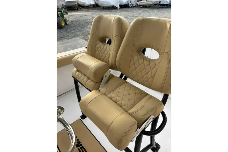 Slide: The Image of 2021 Sportsman Heritage 231 Center Console boat seats with tan upholstery and diamond stitching. - 13