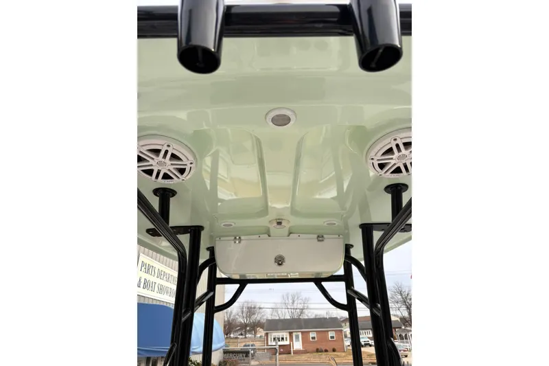 Slide: The Image of 2021 Sportsman Heritage 231 Center Console boat's T-top with speakers and rod holders. - 15