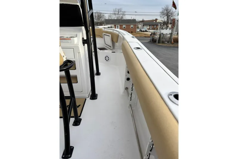 Slide: The Image of 2021 Sportsman Heritage 231 Center Console boat interior with beige seating and white deck. - 18