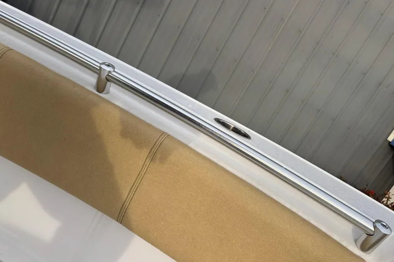 Slide: The Image of 2021 Sportsman Heritage 231 Center Console boat railing and beige cushion detail. - 19