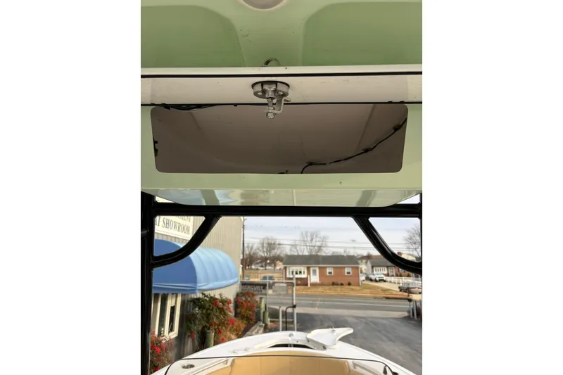 Slide: The Image of 2021 Sportsman Heritage 231 Center Console boat interior view with overhead compartment. - 23