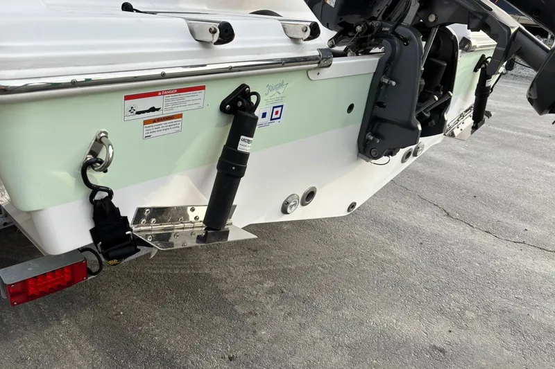 Slide: The Image of 2021 Sportsman Heritage 231 Center Console boat rear view with motor and trailer. - 4