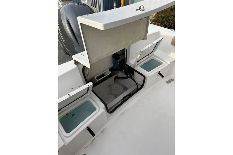 Slide: The Image of 2021 Sportsman Heritage 231 Center Console boat with open storage compartments. - 8