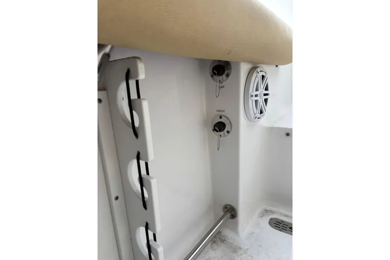 Slide: The Image of 2021 Sportsman Heritage 231 Center Console interior with rod holders and speaker. - 9
