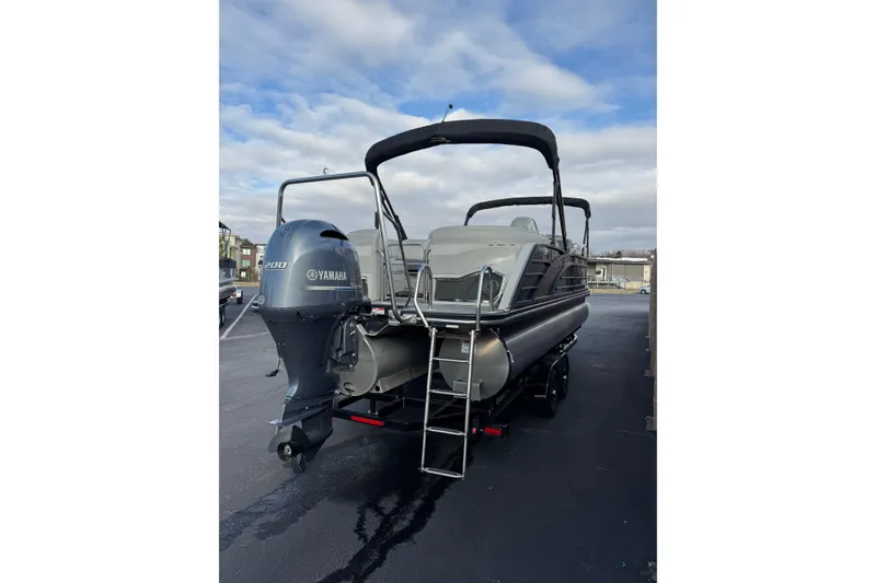 Slide: The Image of 2022 Bennington R23 pontoon boat with Yamaha 200 engine, parked on a trailer. - 3