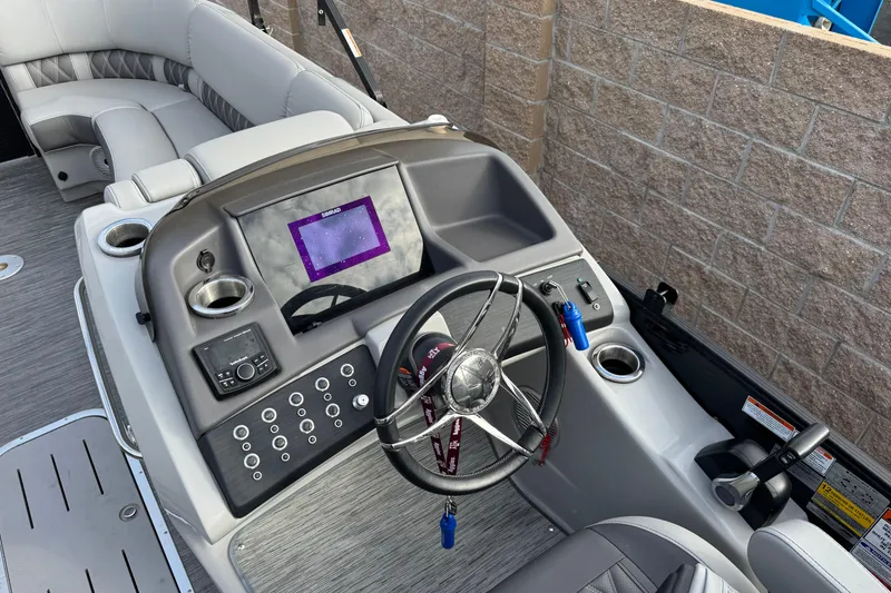 Slide: The Image of 2022 Bennington R23 boat dashboard with steering wheel, touchscreen, and controls. - 5